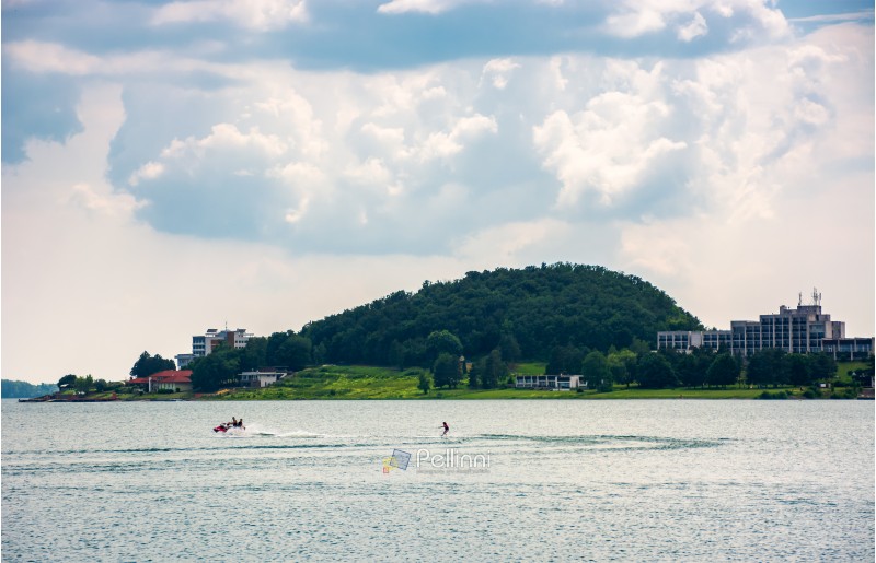 Medvedia mountain over the Zemplinska Sirava lake, Slovakia. Lovely place for vacation or weekend in summer. people water skiing on one of the largest Slovakian body of water