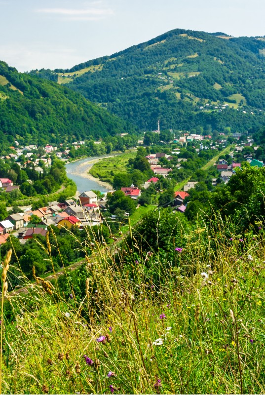 Rakhiv town in summer view from the hill. beautiful scenery in Carpathian mountains. Tisza river winds through the valley