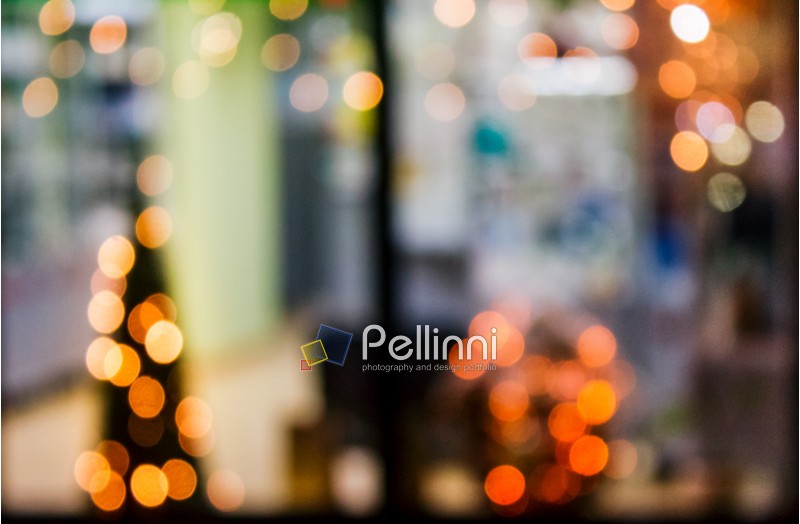 abstract background with bokeh effect of blurred warm lights in window of a shop