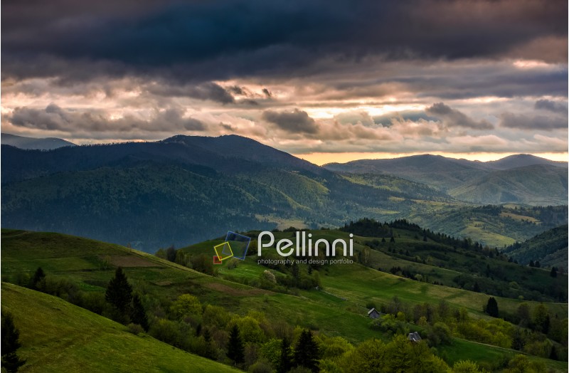 agricultural fields on hills in mountainous rural area at sunset