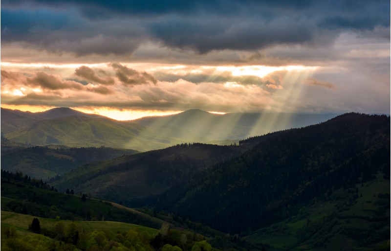 beams of light over the mountains. beautiful landscape in stormy weather