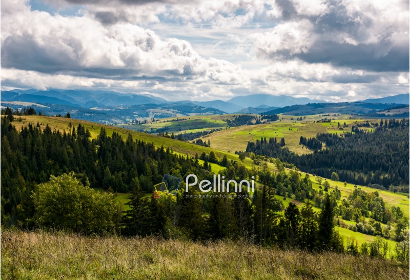 beautiful countryside landscape with rural fields in mountains on a cloudy day. gorgeous autumnal scenery in Carpathian Mountains