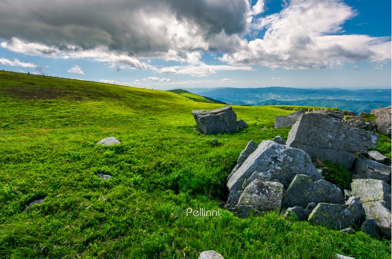 boulders on a grassy slopes of Runa mountain. lovely mountainous landscape on a cloudy summer day