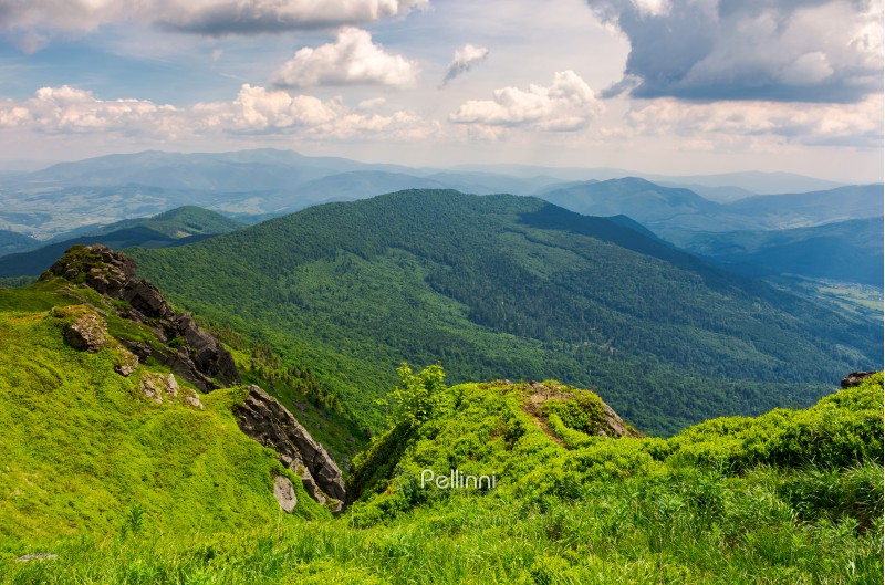 cliffs and grassy hills of Pikui mountain. beautiful view from the top. Borzhava ridge in the distance. lovely summer scenery with beautiful cloudscape