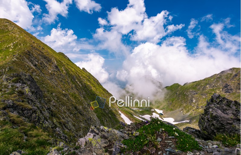 clouds rising above the mountain ridge. lovely summer scenery in Fagaras mountains, Romania