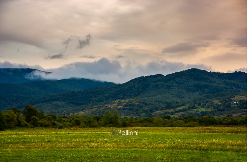 dawn in mountainous countryside. clouds rising above the hills. lovely autumn landscape