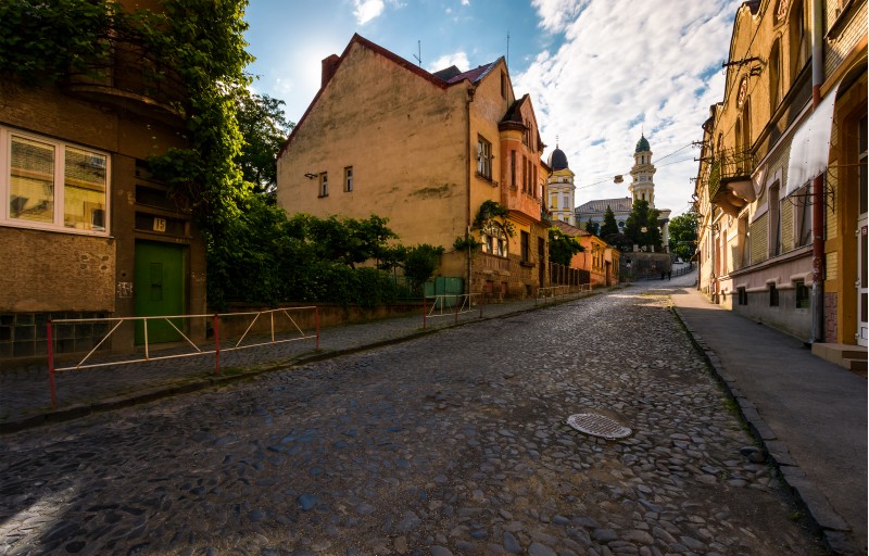 empty street of old town on summer morning. cobblestone pavement on the ground. beautiful scenery with architecture of Austria-Hungary times.