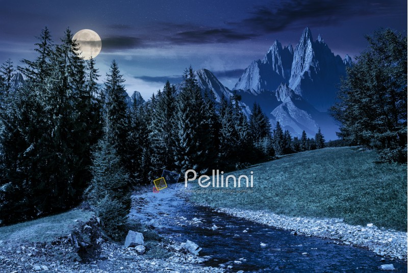 fairy tale mountainous summer landscape at night in full moon light. composite image with high rocky peaks above the mountain river in spruce forest
