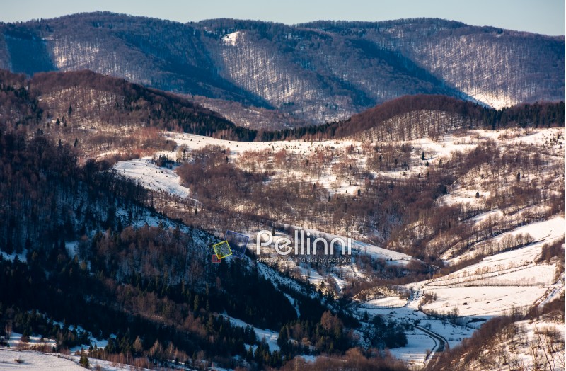 forest on hill in rural area in winter. beautiful textures and patterns on nature viewed from above