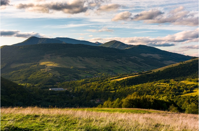 grassy slope in mountainous countryside at sunset. beautiful landscape with gorgeous cloudscape over the hills of Carpathian mountains. location Nyzhni Vorota, Volovets district of TransCarpathia, UA