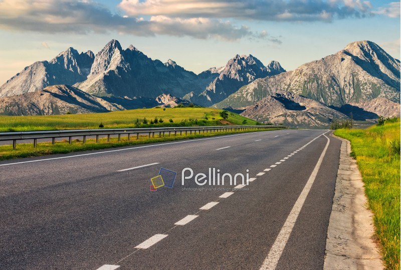 Travel destination concept image. Composite landscape of High Tatra mountain ridge. Straight asphalt highway through green hills leads to high peaks.
