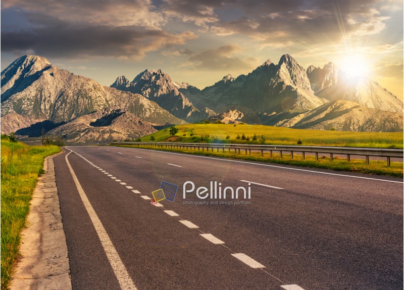 Travel destination concept image. Composite landscape of High Tatra mountain ridge at sunset. Straight asphalt highway through green hills leads to high peaks.