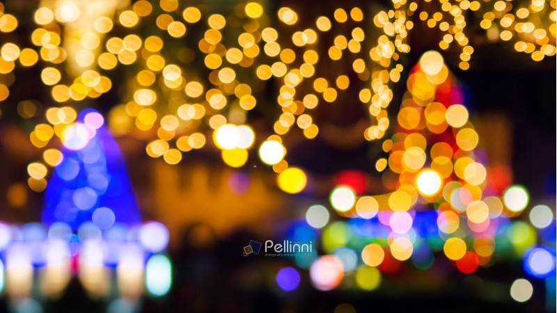 new year in the town concept. two Christmas trees and street lights. abstract composite blurry background.