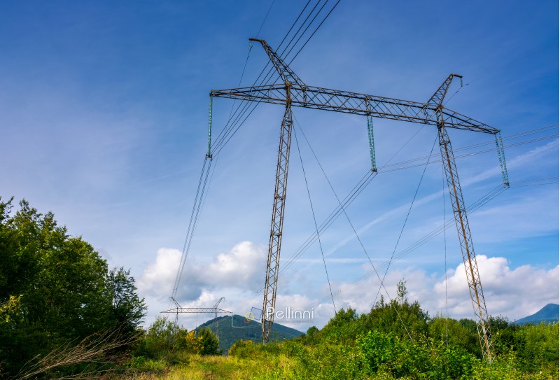 power line tower on a hillside. giant metal construction in beautiful landscape. power and energy concept