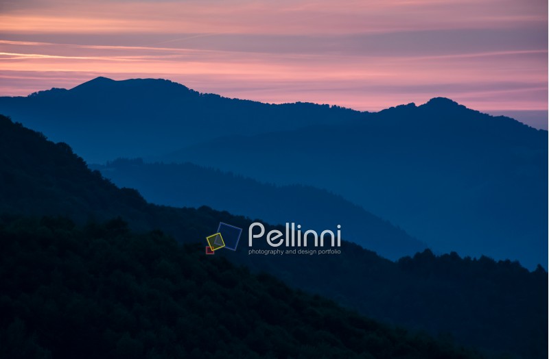 spectacular landscape with reddish sky at dawn in mountains