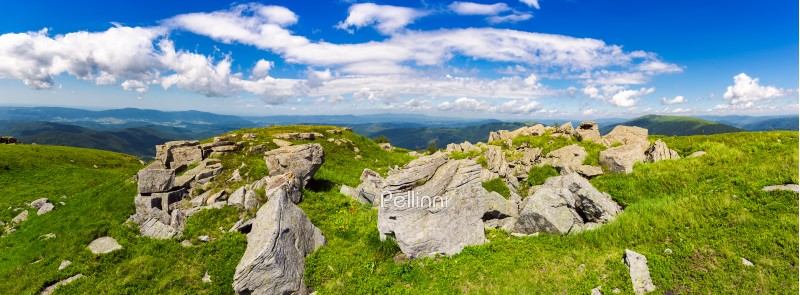 rocks of Runa mountain. panoramic view. wonderful cloudscape on a blue sky over the distant mountain range. breathtaking view of mountainous summer landscape in Carpathians