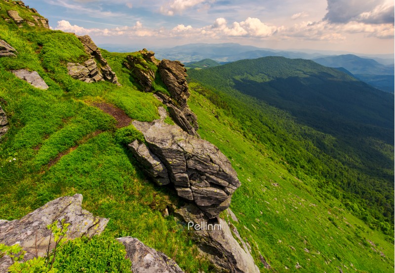 rocky cliffs of the Pikui mountain. Borzhava mountain ridge in the far distance. Beautiful summer landscape on a cloudy day