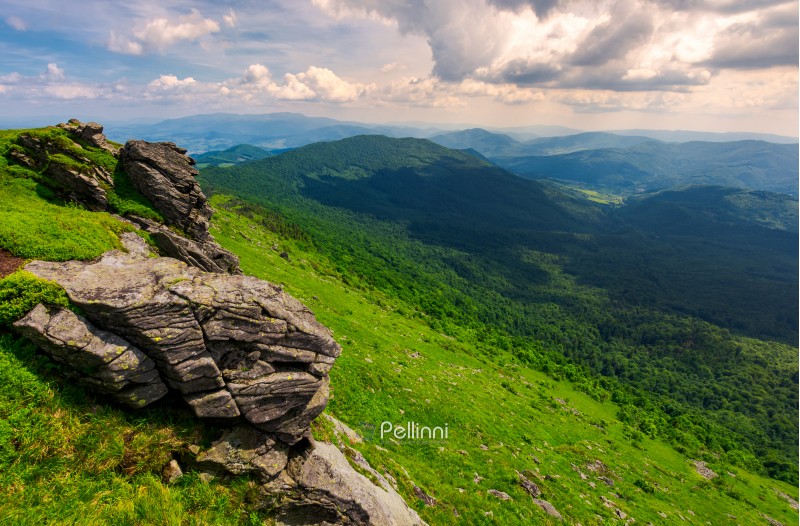 rocky cliffs of the Pikui mountain. Borzhava mountain ridge in the far distance. Beautiful summer landscape on a cloudy day
