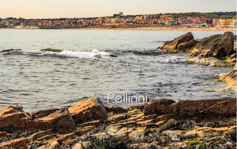 SOZOPOL, BULGARIA - SEPTEMBER 11, 2013: rocky shore and sandy city beach in mellow season. Beautiful and warm weather on the coast of Black sea.