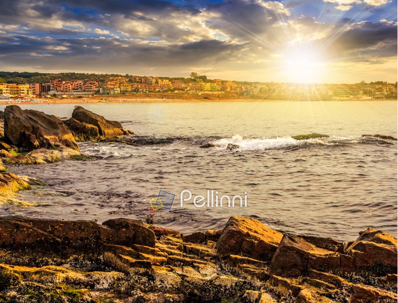 SOZOPOL, BULGARIA - SEPTEMBER 11, 2013: rocky shore and sandy city beach in mellow season. Beautiful and warm weather on the coast of Black sea at sunset.
