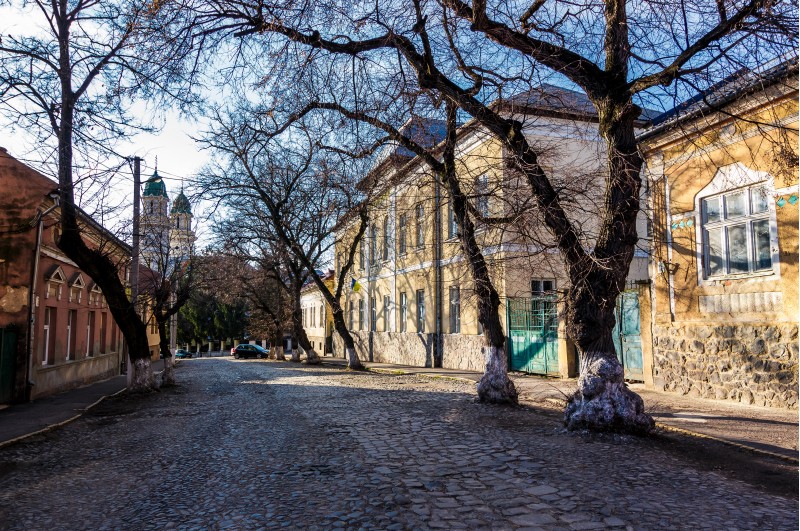 street of old town in sunny spring day. cobblestone road, beautiful architecture and old Cathedral in the distance