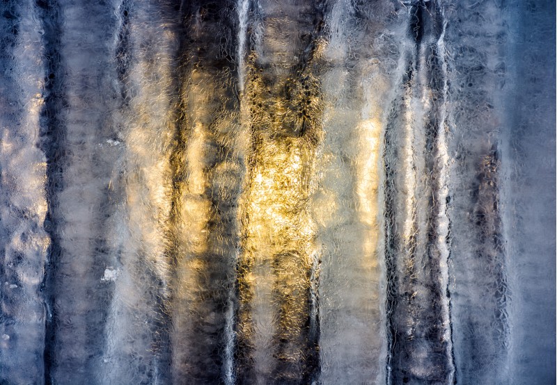 sun behind the ice wall. beautiful winter background with fine frosted textures of the cold surface