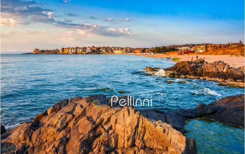 SOZOPOL, BULGARIA - SEPTEMBER 9, 2013: sunrise on sandy city beach in mellow season. Beautiful and warm weather on the shores of Black sea.