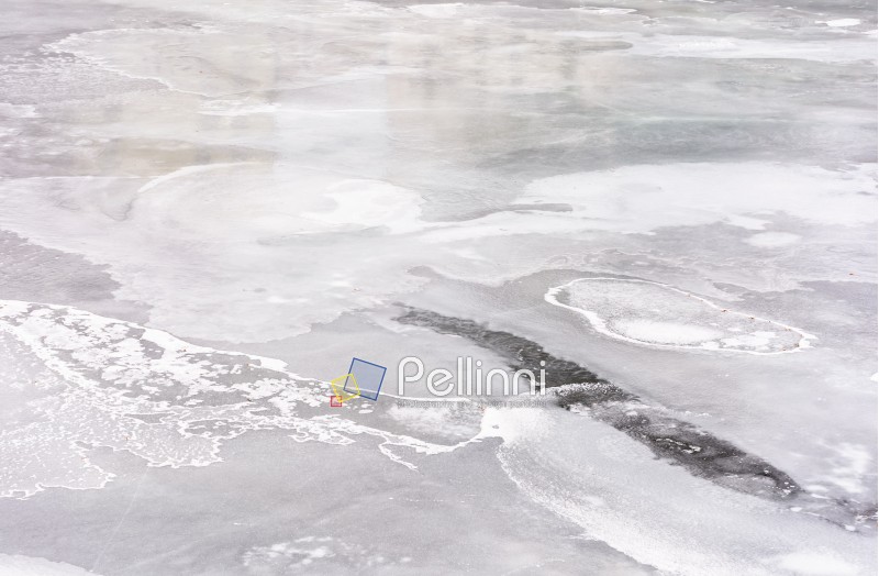 texture of ice on a frozen river. lovely nature background in winter