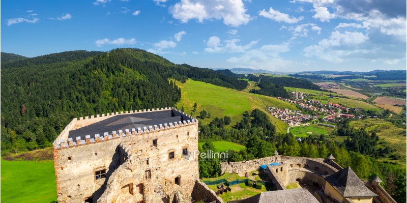Stara Lubovna, Slovakia - AUG 28, 2016: view from the top of castle wall. beautiful rural landscape. village at the foot of the forested hill