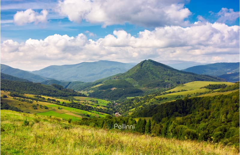 Abranka village in the valley of Carpathian mountains, Ukraine. lovely countryside scenery in early autumn with clouds distant ridge.