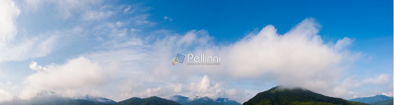 wonderful dynamic cloudscape above the mountain ridge. beautiful panoramic nature background