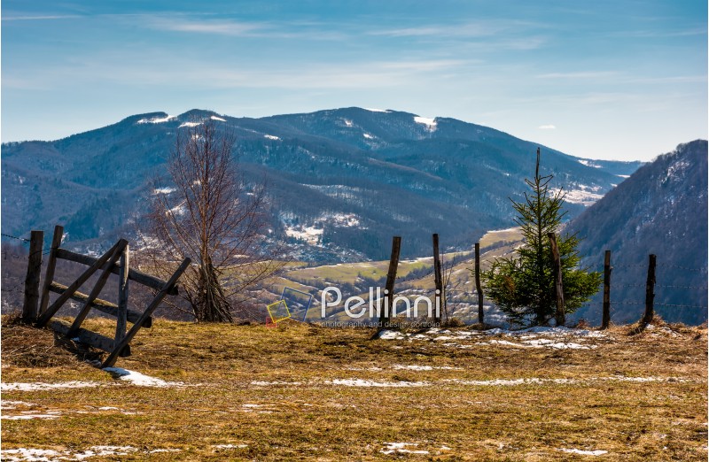 wooden fence on the edge of a hillside. beautiful countryside springtime landscape in mountains