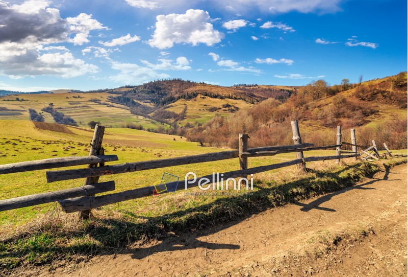 wooden fence on hillside in the rural area