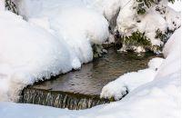 brook with cascades in winter. lovely nature background