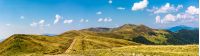 footpath through rolling hills of mountain ridge. gorgeous panorama of early autumn landscape with fine weather and blue sky with some clouds. hiking direction concept
