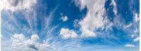 gorgeous cloudscape panorama on a blue summer sky. beautiful weather background with dynamic cloud arrangement