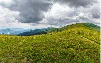 summer mountain landscape under the sky with heavy clouds
