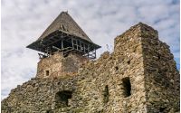 Nevytsky Castle, Ukraine - October 27, 2016: tower with wooden roof and stone wall of mighty Nevytsky Castle. popular travel destination of Transcarpathia