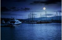 yacht at the pier of the old city  at night in full moon light