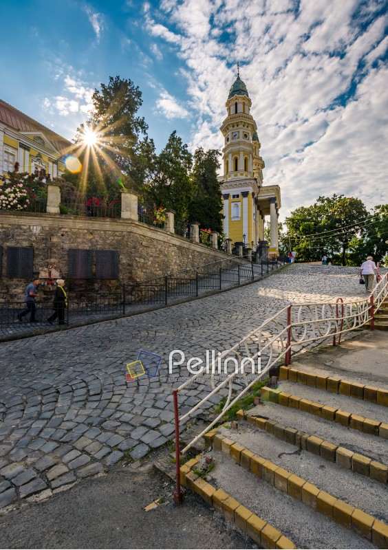 Uzhgorod, Ukraine - Jun 11, 2017: people go uphill to the Greco Catholic cathedral. everyday life in the central part of the beautiful old down in the morning
