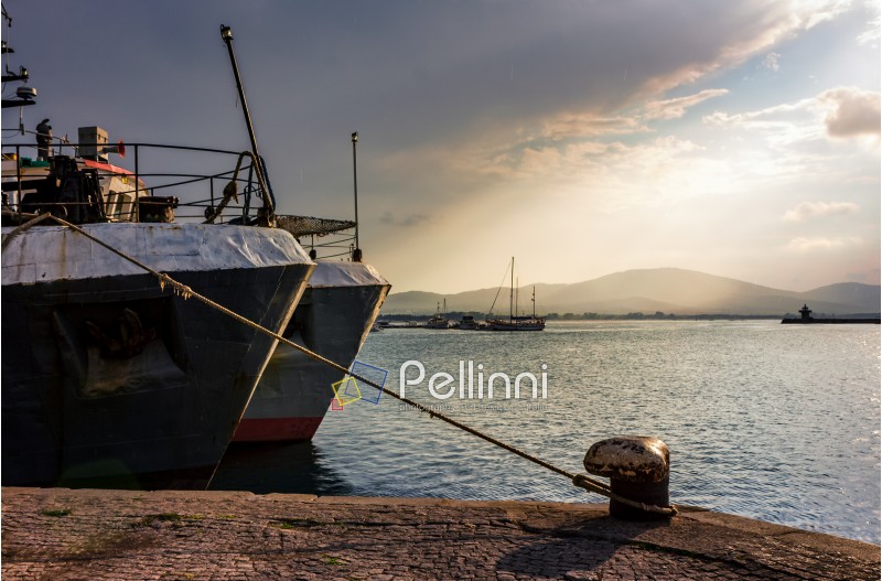 Boats docked to a mooring bollard in the  port of Bulgarian town Sozopol at sunset
