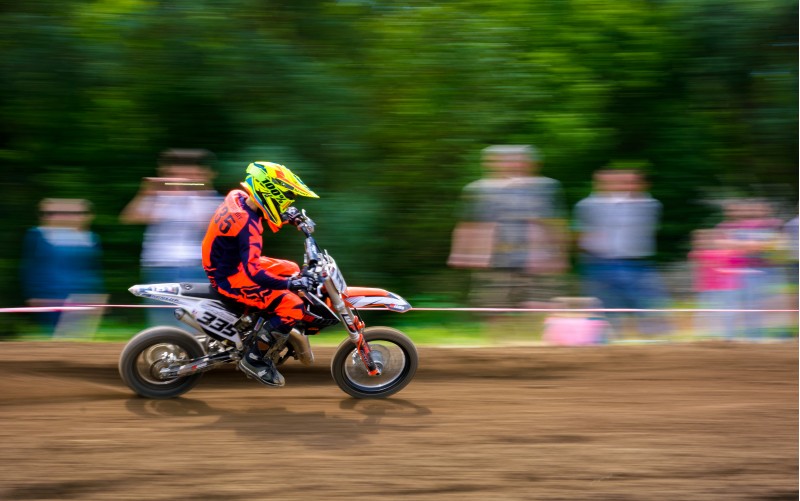 Uzhgorod, Ukraine - May 21, 2017: Junior MX rider turns on a corner. Motion blur with flying dirt. TransCarpathian regional Motocross Championship