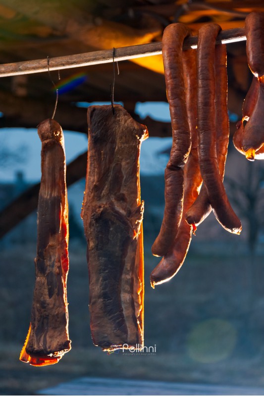 Hecha, Ukraine - JAN 27, 2018: Pork butchers competition. Smoked bacon and sausages hang on the bar. tasty traditional food