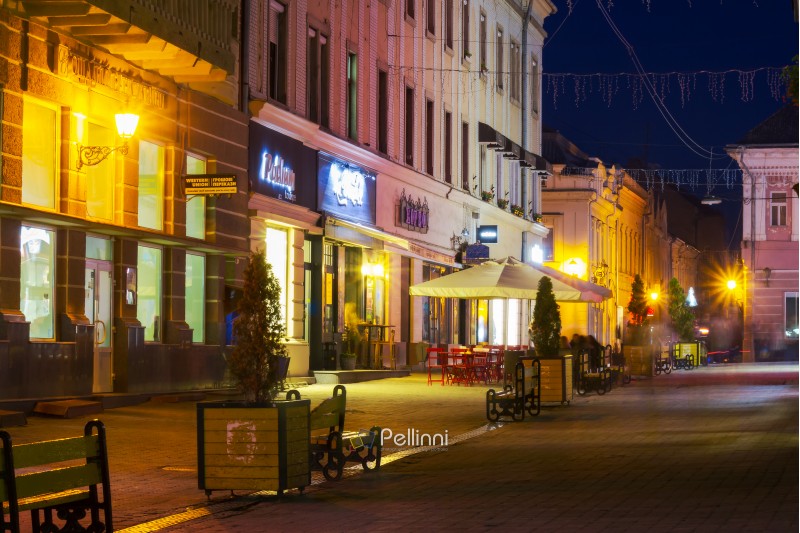 Uzhgorod, Ukraine - OCT 25, 2014: Korzo street in evening. main street of the old town. popular tourist destination and meeting place for local people