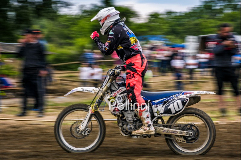 Uzhgorod, Ukraine - May 21, 2017: MX rider Finish the race. Motion blur with flying dirt. TransCarpathian regional Motocross Championship