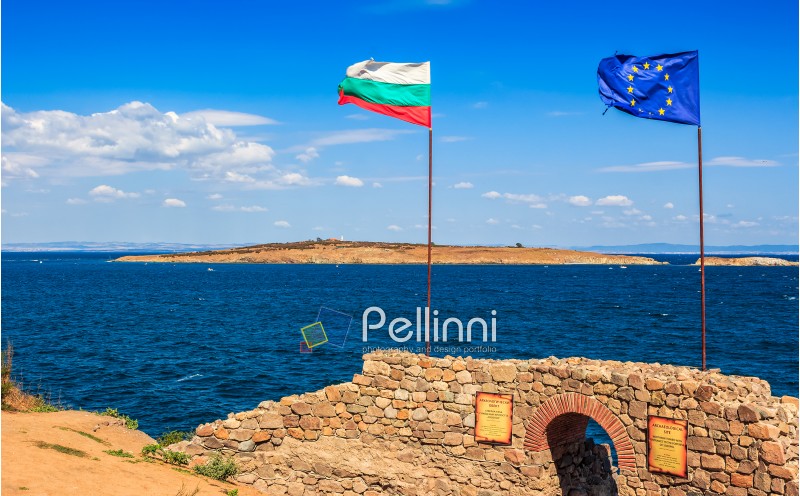 SOZOPOL, BULGARIA - SEPTEMBER 08, 2013: Northen tower with entrance to the fortress of sozopol. European and Bulgarian flag wave abow the Black Sea shore. st Ivanand and st Peter islands are seen in the distance