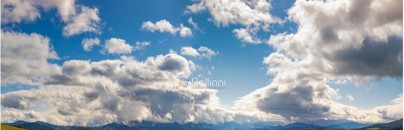 panorama of a gorgeous cloudscape above the mountain ridge. beautiful natural background of autumn sky