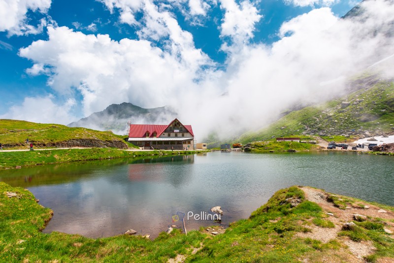 beautiful alpine scenery of fagaras mountains. balea lake in rom beautiful alpine scenery of fagaras mountains. balea lake in romania mountain landscape. summer weather with clouds on sky. view of rippled water near rocky slope. remote wilderness travel background