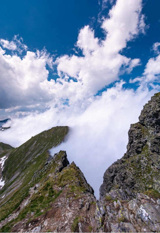 beautiful cloudscape over the cliffs of Fagarasan mountain ridge. lovely nature background on a summer day