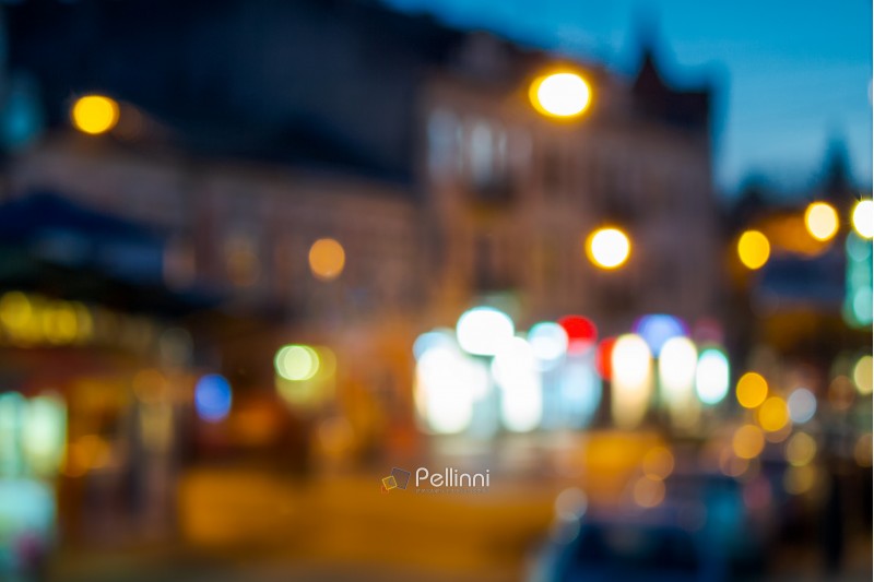 beautiful evening scenery of european town. street with bright lanterns. abstract blur background. bokeh effect